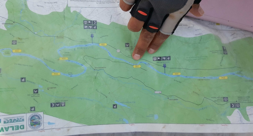 a person points at a map on an outward bound canoeing course